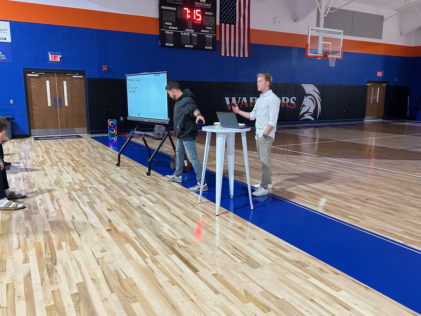Hayden presenting to students in a gym